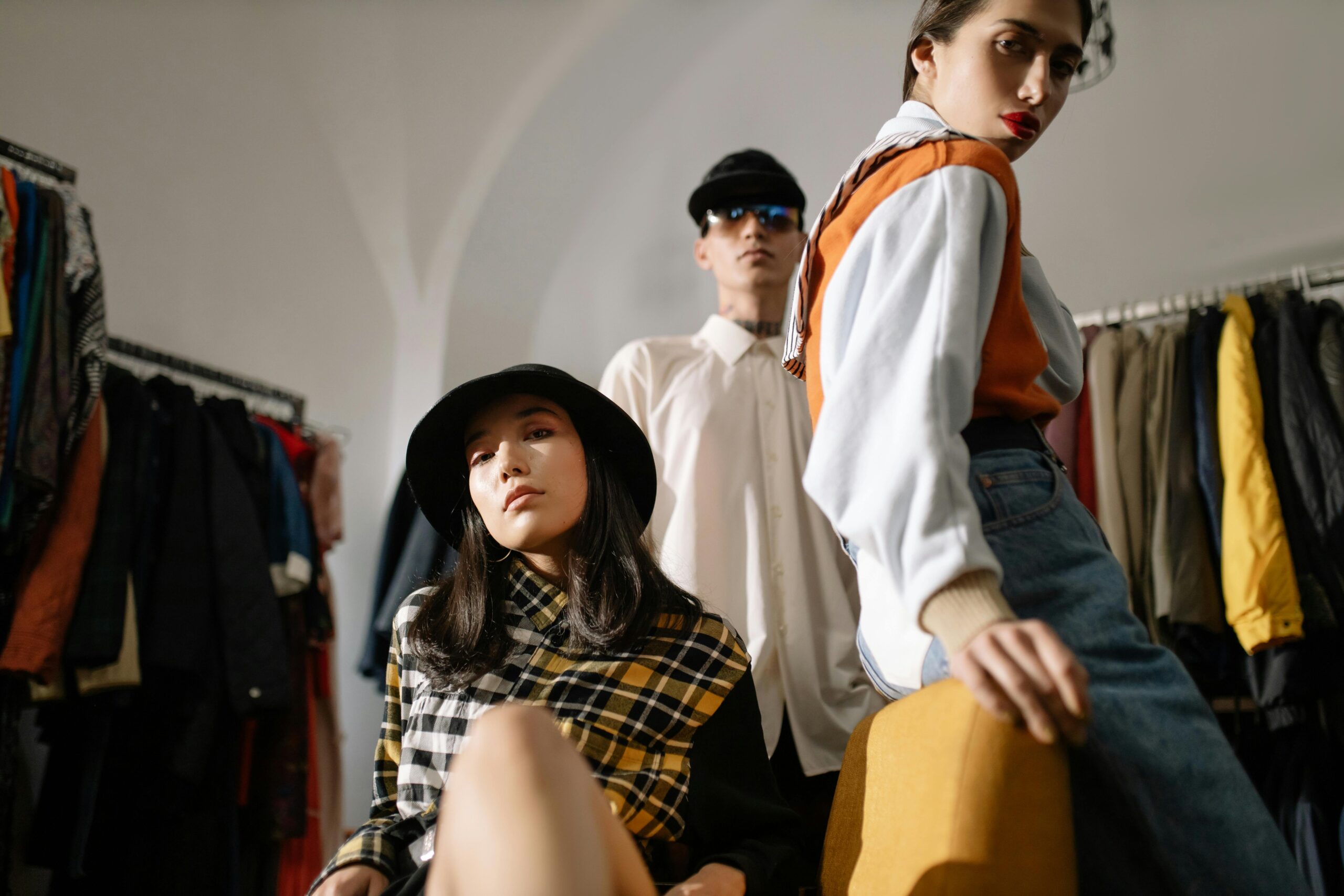 Stylish young models posing in a modern fashion boutique setting.